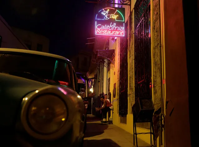Cubans sit outside at the private bar restaurant La California in Havana, Cuba October 13, 2016. (Photo by Enrique de la Osa/Reuters)