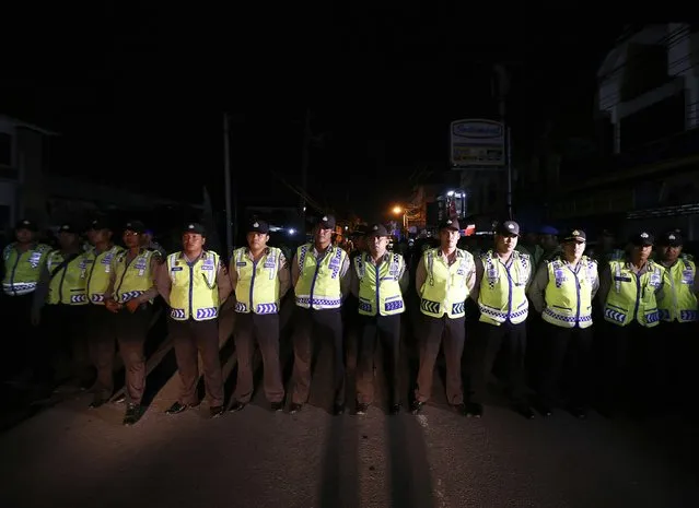 Indonesia policemen stand guard before two Australian death row prisoners, Myuran Sukumaran and Andrew Chan, leave Kerobokan Prison for the airport, in Denpasar, on the Indonesian island of Bali, March 4, 2015. The two convicted Australian drug smugglers were removed from the prison in Bali on Wednesday to be taken to an Indonesian island where they will be shot by firing squad, Australian media reported. The planned executions of Myuran Sukumaran, 33, and Andrew Chan, 31, have ratcheted up diplomatic tensions amid repeated pleas of mercy for the pair from Australia and thrown a spotlight on Indonesia's increasing use of the death penalty for foreigners. REUTERS/Beawiharta 