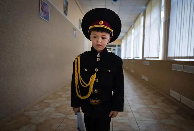 A young cadet heads to his classroom on the first day of school at a cadet lyceum in Kyiv, Ukraine, Monday, September 4, 2023. (Photo by Efrem Lukatsky/AP Photo)