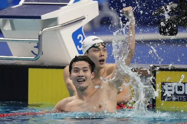 South Korea's Hwang Sunwoo, front, celebrates after winning the men's 200m freestyle swimming final as his compatriot Lee Hojoon who won the third place looks on at the 19th Asian Games in Hangzhou, China, Wednesday, September 27, 2023. (Photo by Lee Jin-man/AP Photo)