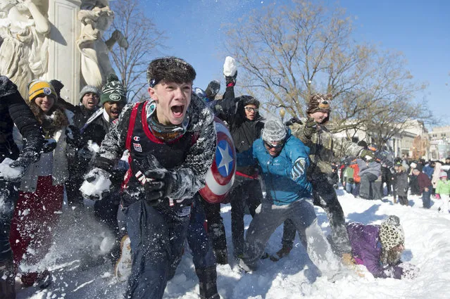 People participate in a snowball fight after this weekend's blizzard, at Dupont Circle in Washington, D.C., Sunday, January 24, 2016. (Photo by Michael Reynolds/EPA)