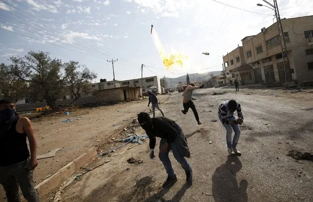 A Palestinian protester hurls a molotov cocktail towards Israeli troops during clashes in the West Bank town of Qabatya, near Jenin February 5, 2016. (Photo by Mohamad Torokman/Reuters)
