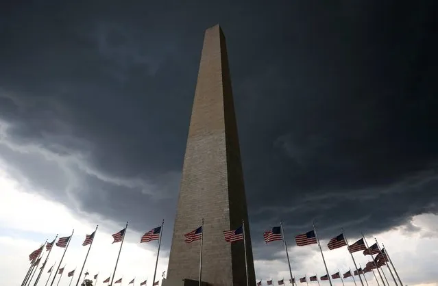 Storm clouds hover above the Washington monument in Washington D.C., U.S., August 15, 2016. (Photo by Mike Hutchings/Reuters)