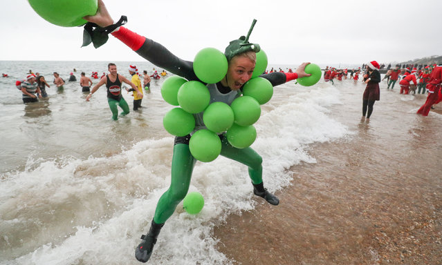 People in fancy dress to take part in the annual White Christmas Dip at Boscombe Pier, Bournemouth, England on December 25, 2018. (Photo by Andrew Matthews/PA Wire Press Association)