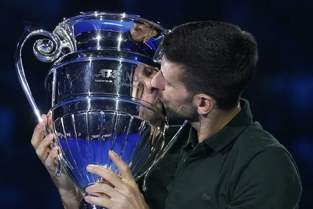 Serbia's Novak Djokovic kisses the trophy as ATP world best player at the ATP World Tour Finals, at the Pala Alpitour, in Turin, Italy, Monday, November 13, 2023. Djokovic was presented with the trophy for finishing the year ranked No. 1. (Photo by Antonio Calanni/AP Photo)