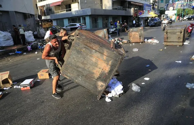 Saad Hariri's supporters block streets in Beirut, Lebanon, Thursday, July 15, 2021. Prime Minister-designate Saad Hariri says he is stepping down, nine months after he was named to the post by the parliament. He is citing “key differences” with the country's president, Michel Aoun. Thursday's announcement is likely to plunge the country further into more chaos and uncertainty. (Photo by Hussein Malla/AP Photo)