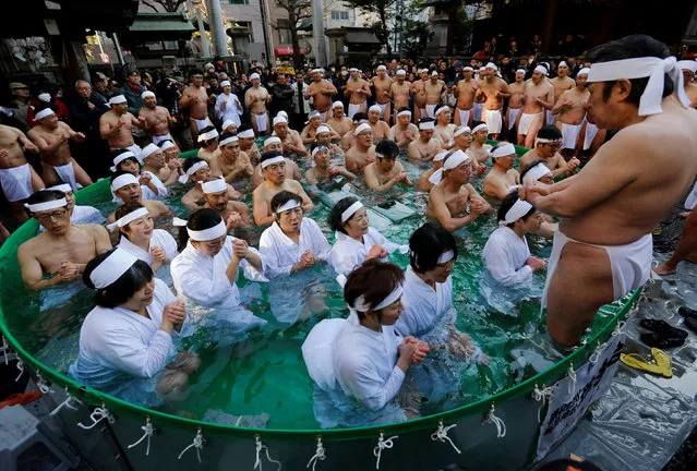 People wearing loincloths pray as they bathe in ice-cold water in a ceremony to purify their souls and wish for good health in the new year at the Teppozu Inari shrine  in Tokyo, Japan, January 13, 2019. (Photo by Issei Kato/Reuters)
