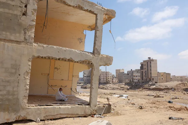 A volunteer rests inisde a destroyed home following fatal floods in Derna, Libya on September 16, 2023. (Photo by Amr Alfiky/Reuters)