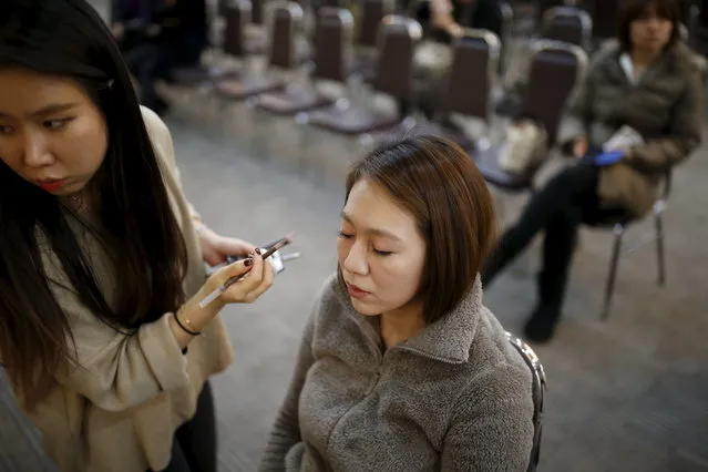 A Japanese bride receives a makeover as she prepares for an upcoming mass wedding ceremony of the Unification Church at a resort in Yangpyeong, South Korea, February 19, 2016. (Photo by Kim Hong-Ji/Reuters)