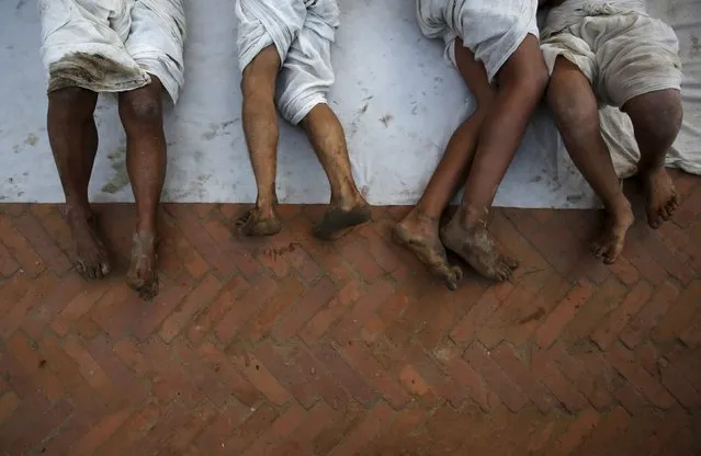 Feet of devotees are pictured as they offer prayers by rolling on the street during the final day of the month-long Swasthani Brata Katha festival in Bhaktapur, Nepal, February 22, 2016. (Photo by Navesh Chitrakar/Reuters)