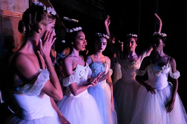 Ballet dancers react backstage as they perform “Giselle” during the 27th Alicia Alonso International Ballet Festival of Havana, at the National Theatre, in Havana, Cuba on October 30, 2022. (Photo by Alexandre Meneghini/Reuters)