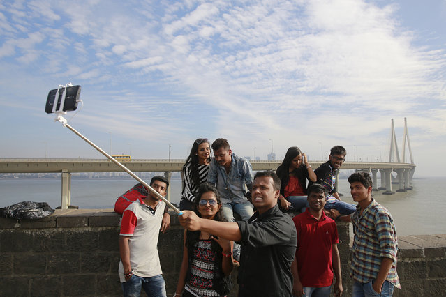 In this February 22, 2016, photo, Indians take a selfie in Mumbai's coastline. India is home to the highest number of people who have died while taking photos of themselves, with 19 of the world's 49 recorded selfie-linked deaths since 2014, according to San Francisco-based data service provider Priceonomics. The statistic may in part be due to India's sheer size, with 1.25 billion citizens and one of the world's fastest-growing smartphone markets. (Photo by Rafiq Maqbool/AP Photo)