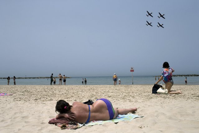 Israeli Air Force Fuga aircrafts fly over the coastline during training for Israel's upcoming Independence day, in Tel Aviv, Monday, April 20, 2015. Israel will celebrate the 67th anniversary of the founding of the state beginning at sundown Wednesday through Thursday. (Photo by Oded Balilty/AP Photo)