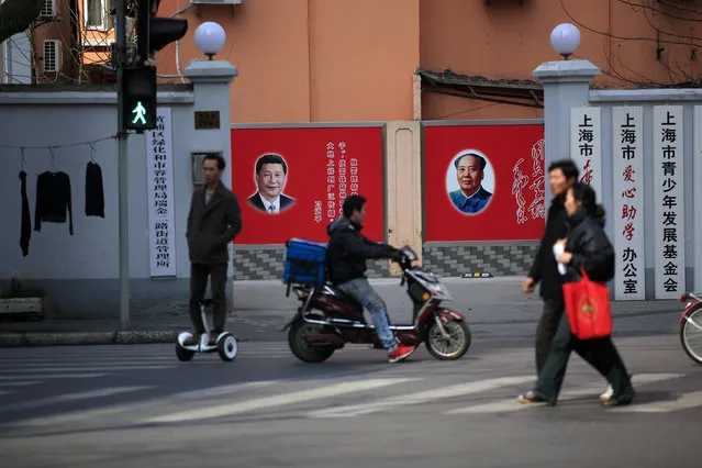 People cross a street beside posters depicting the late Chairman Mao Zedong (R) and China's President Xi Jinping in Shanghai, China March 1, 2016. (Photo by Aly Song/Reuters)