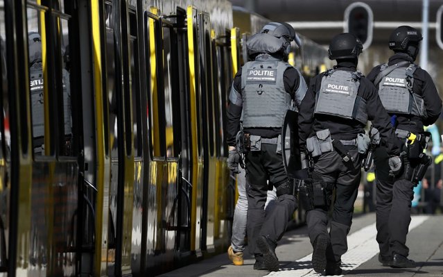 Police forces walk near a tram at the 24 Oktoberplace in Utrecht, on March 18, 2019 where a shooting took place. A gunman who opened fire on a tram in the Dutch city of Utrecht on March 18, injuring several people, is on the run, police said. Police only spoke of one gunman but did not rule out the possibility there might be others, the ANP news agency quoted police as saying. (Photo by Robin van Lonkhuijsen/ANP/AFP Photo)