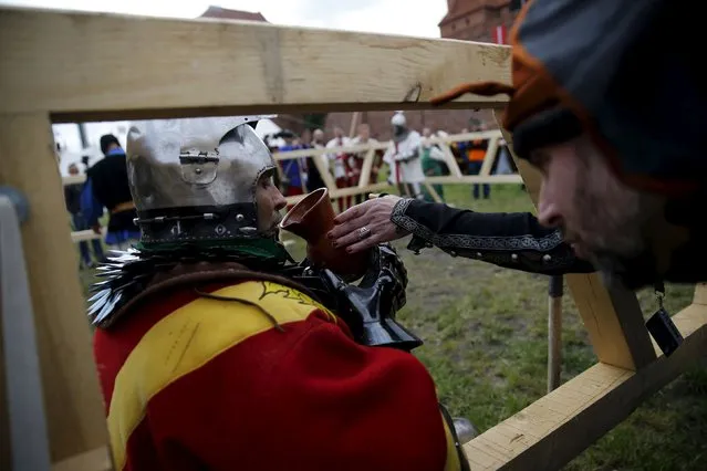 Spanish fighter Jose Amoedo drinks water during break in his pole arm duel with English fighter Pawel Kurzak during the Medieval Combat World Championship at Malbork Castle, northern Poland, April 30, 2015. (Photo by Kacper Pempel/Reuters)