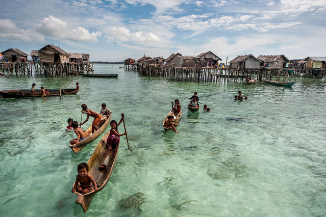 The Bajau people of Malaysia live their lives completely at sea, living in wooden huts and spending their days fishing. Sailing over crystal clear waters, the Bajau people of Malaysia live their lives almost entirely at sea. Children as young as four catch fish, octopus and lobsters from handmade boats off the eastern coast of Sabah, Malaysia. (Photo by Ng Choo Kia/Hotspot Media/SIPA Press)