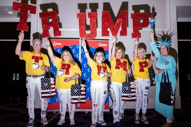 A group of Trump supporters hold up signs at the Conservative Political Action Conference (CPAC) annual meeting in National Harbor, Maryland, U.S., February 22, 2024. (Photo by Amanda Andrade-Rhoades/Reuters)