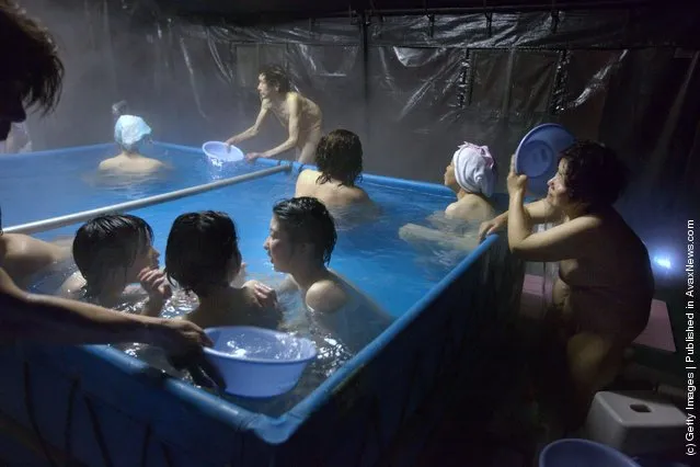 Japanese earthquake victims enjoy a communal bath set up in tents by the Japanese Self Defense Force