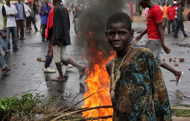 A protester poses for a photograph as they barricade a road to demonstrate against plans by Burundian President Pierre Nkurunziza to run for a third five-year term in office, in Bujumbura, May 8, 2015. (Photo by Jean Pierre Aime Harerimana/Reuters)