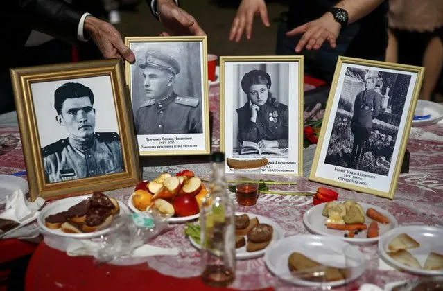 Photos of World War Two Soviet soldiers are on display during the celebrations for the Victory Day at the Gorky Central Park of Culture and Leisure in Moscow, Russia, May 9, 2015. (Photo by Maxim Zmeyev/Reuters)