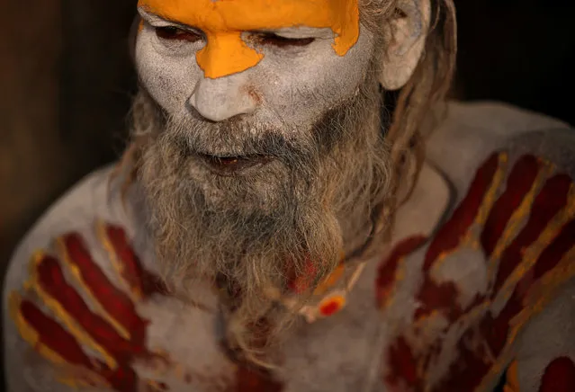 A Hindu holy man, or sadhu, smeared with ashes sits at the premises of Pashupatinath Temple, ahead of the Shivaratri festival in Kathmandu, Nepal February 21, 2017. (Photo by Navesh Chitrakar/Reuters)