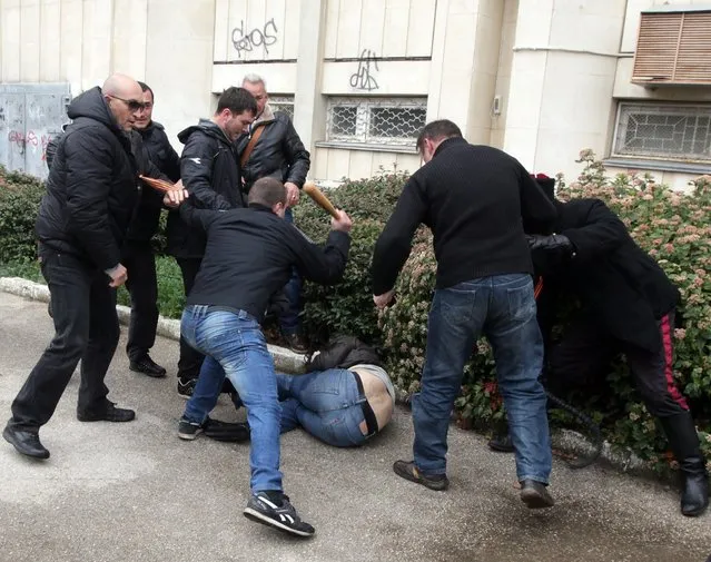 People beat up another man during clashes of Pro-Russian and Pro-Ukrainian activists during a rally in Sevastopol, Crimea, Ukraine, 09 March 2014. The USA and European Union have threatened sanctions against Moscow over the military standoff in the strategic Crimean peninsula, and are urging Russia to pull back its forces in the region and allow in international observers and human rights monitors. Crimea, which has a majority ethnic Russian population, is strategically important to Russia as the home port of its Black Sea Fleet. (Photo by EPA/STR)