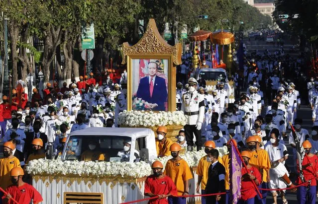 Cambodian officers stand next to a portrait of former Prime Minister Prince Norodom Ranariddh during his funeral ceremony in Phnom Penh, Cambodia, 08 December 2021. Thousands of Cambodians gathered to honor former Prime Minister Prince Norodom Ranariddh before his cremation after he passed away on 28 November 2021 in France, at the age of 77. (Photo by Mak Remissa/EPA/EFE)