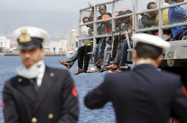 Migrants wait to disembark from the Migrant Offshore Aid Station (MOAS) ship MV Phoenix in the Sicilian harbour of Messina, Italy May 16, 2015. (Photo by Antonio Parrinello/Reuters)