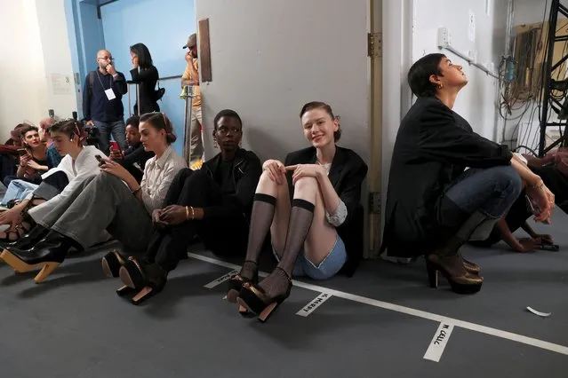 Models wait backstage to rehearse before presenting the creations from the Dior pre-fall 2024 women's collection at the Brooklyn Museum in New York City, New York, U.S., April 15, 2024. (Photo by Caitlin Ochs/Reuters)