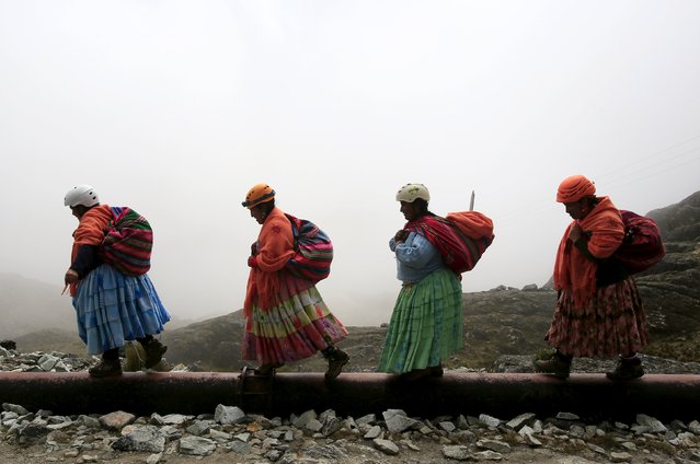 Aymara indigenous women walk toward Huayna Potosi mountain, Bolivia April 6, 2016. (Photo by David Mercado/Reuters)