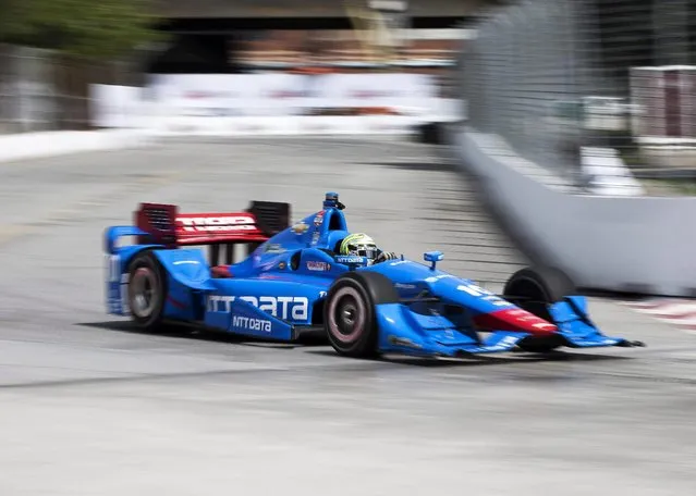 Tony Kanaan, of Brazil, makes a corner during practice for the IndyCar auto race Saturday, June 13, 2015, in Toronto. (Aaron Vincent Elkaim/The Canadian Press via AP)