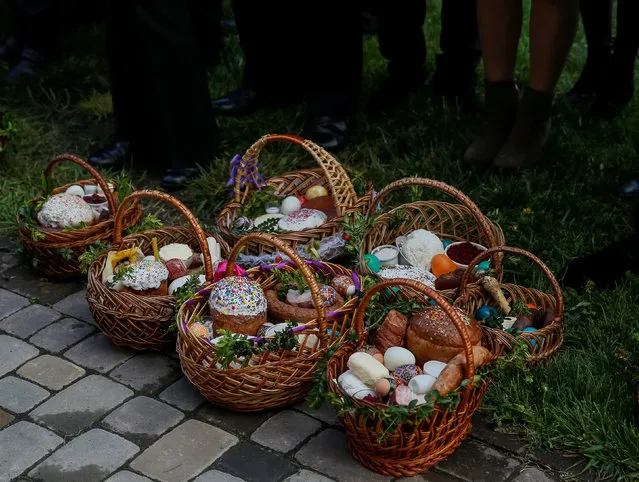 Believers prepare “paskha” cakes, eggs and other food to be consecrated at the Greek-Catholic church ahead of midnight Easter mass in Pustomyty village near Lviv, Ukraine, April 30, 2016. (Photo by Gleb Garanich/Reuters)