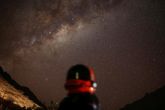 Ricardo Barriga, 10, who wants to be an astronomer, poses for a photograph while wearing an astronaut's outfit before a total solar eclipse, in Valle Luz de la Luna, Chile on July 2, 2019. (Photo by Pablo Sanhueza/Reuters)