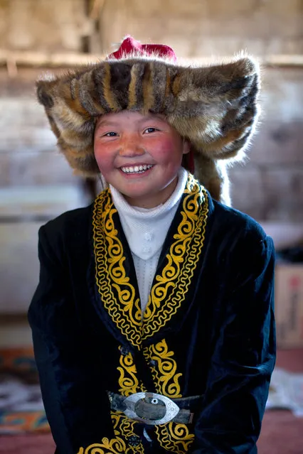 13 year old Ashol Pan. These stunning photographs show the changing face of a majestic centuries old Kazakh pastime tradition  that still lives in the lands of mongolia – eagle hunters. (Photo by Asher Svidensky/Caters News)