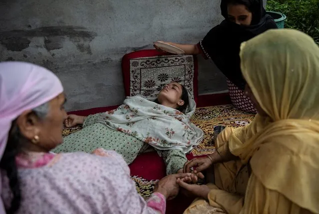 Bilquis, sister of Irfan Ahmad Hurra, who according to the relatives was arrested during a clampdown after the scrapping of the special constitutional status for Kashmir by the government, is attended by her relatives after she fainted while crying as she mourns inside their house, in Pulwama, south of Srinagar, August 13, 2019. (Photo by Danish Siddiqui/Reuters)