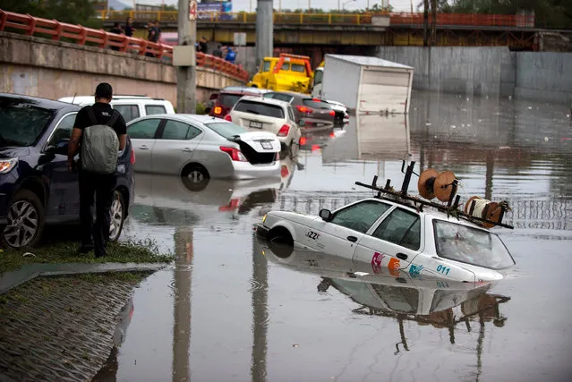 Vehicles sit in water after heavy rains from Tropical Storm Ivo hit Monterrey in the state of Nuevo Leon, Mexico, 24 August 2019. The phenomenon will continue to cause heavy rains that could lead to more flooding in northwestern Mexico. (Photo by Miguel Sierra/EPA/EFE)