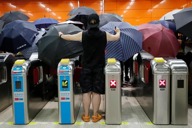 Anti-extradition bill protesters open umbrellas as they demonstrate at a Mass Transit Railway (MTR) station, at Po Lam, in Hong Kong, China on September 4, 2019. (Photo by Tyrone Siu/Reuters)