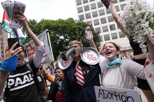 Protestors march near the Fiserv Forum during the first day of the 2024 Republican National Convention, Monday, July 15, 2024, in Milwaukee. (Photo by Jae C. Hong/AP Photo)