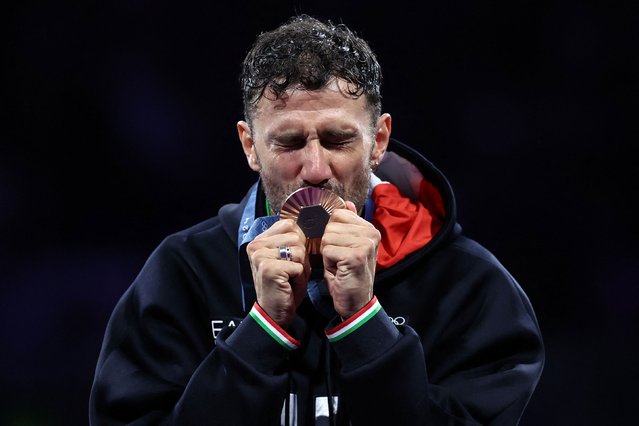 Bronze medallist Luigi Samele of Italy celebrates on the podium during the medal ceremony for the men's individual sabre competition on July 27, 2024. (Photo by Franck Fife/AFP Photo)