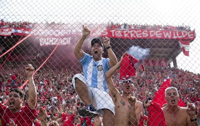 Independiente's fans celebrate their team's fourth goal during an Argentine league soccer match against Racing Club in Buenos Aires, Argentina, Saturday April 14, 2012. (Photo by Natacha Pisarenko/AP Photo)