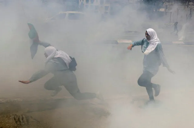 Palestinian school girls run for cover from tear gas fired by Israeli troops during clashes at a protest marking the 69th anniversary of Nakba, in the West Bank town of Bethlehem May 15, 2017. (Photo by Ammar Awad/Reuters)