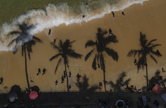 A picture taken with a done, shows people taking advantage of the hot day during the Brazilian summer at Urca beach, in Rio de Janeiro, Brazil 03 March 2022. The heat wave in the city left the temperatures close to 40 degrees celcius, 104 fahrenheit, in some parts of the city of Rio de Janeiro. (Photo by Antonio Lacerda/EPA/EFE)
