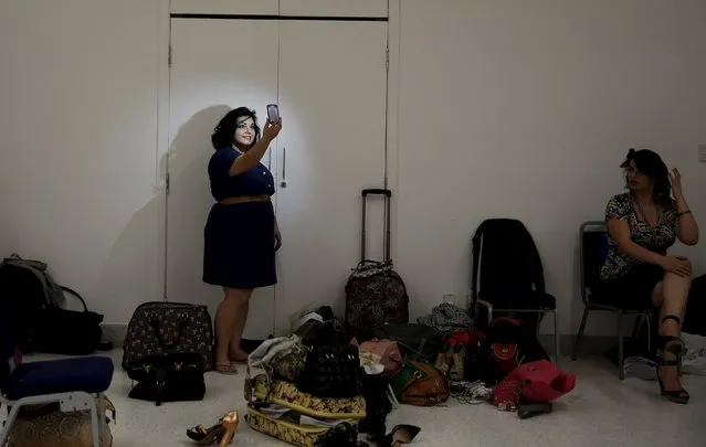 A model takes a picture of herself with a mobile phone backstage before a presentation as part of Fashion Weekend Plus Size Summer 2015 collection show in Sao Paulo, July 25, 2015. (Photo by Nacho Doce/Reuters)