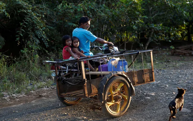 A retrenched worker of nickel-ore mine Zambales Diversified Metals Corporation ordered closed by Environment secretary Regina Lopez, rides on a tricycle with his children in Sta Cruz Zambales in northern Philippines February 7, 2017. (Photo by Erik De Castro/Reuters)