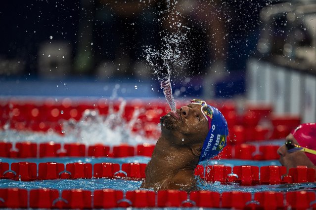 Paralympic athlete Araujo dos Santos, of Brazil, spits water to celebrate his victory in the men’s 100-meter backstroke -S2 final, at the 2024 Paralympics, in Paris, August 29, 2024. (Photo by Emilio Morenatti/AP Photo)