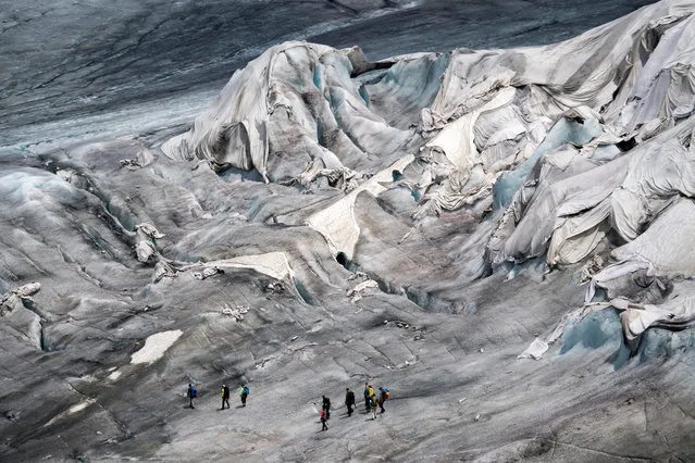 A general view over the Rhone Glacier covered in blankets above Gletsch near the Furkapass, Switzerland, 24 June 2017. The Alps oldest glacier is protected by special white blankets to prevent it from melting. (Photo by  Urs Flueeler/EPA)