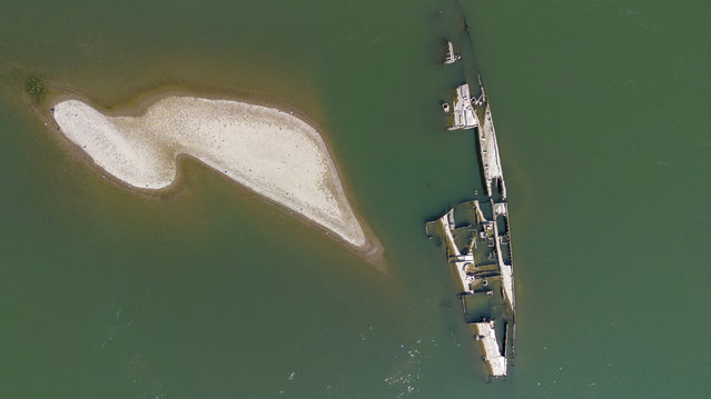 A drone image shows a sunken German warship from World War II, exposed due to low Danube river levels caused by drought and extreme heat, in Prahovo, Serbia, on September 5, 2024. (Photo by Djordje Kojadinovic/Reuters)