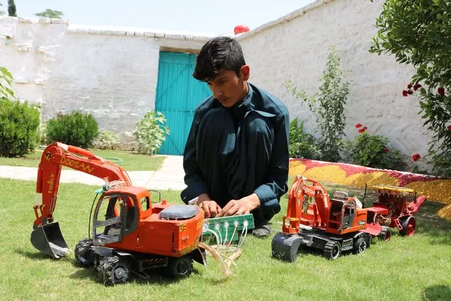 Shakirullah, a 16-year-old student, collects discarded materials to build various model vehicles such as excavator, bulldozer, tractor and some other machines in Khost, Afghanistan on May 14, 2022. (Photo by Sardar Shafaq/Anadolu Agency via Getty Images)