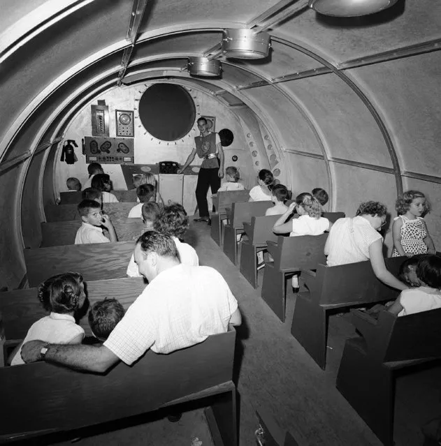 The youngsters are seated inside the 76-foot rocket at Spaceland in Garden City, New York, July 21, 1958 as Bill Jaker, as Captain Demos, gets ready to blast off. The rocket is equipped with space instrument controls and an “outer space” viewing screen. (Photo by Carl Nesensohn/AP Photo)